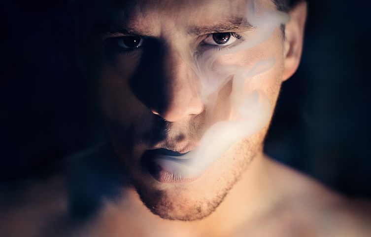 Man with smoke coming out from his mouth